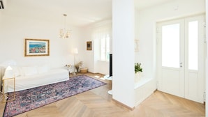 A modern living room with a white sofa, a patterned rug, and a television. - Hedera Estate, Hedera A8 (Dubrovnik)