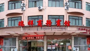 A building with a sign that reads "瑞祥商务宾馆" (Ru xiang gong zuo binan).