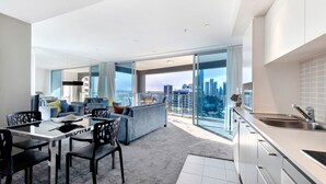 A modern apartment with a balcony, a dining area, and a kitchen.