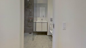 A modern bathroom with a shower, a sink, and a toilet. - 3-bed in Frederiksberg w Balcony - 210 (Frederiksberg)