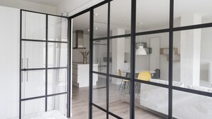 A modern interior with a large sliding glass door leading to a dining area. - Fantastic 1-bed Apartment w Private Terrace (Aarhus)
