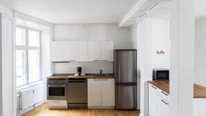 A modern kitchen with white cabinets, stainless steel appliances, and a wooden countertop. - Lovely 2-bedroom Apartment in the Heart of Copenhagen - 62 (Copenhagen)