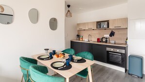 A modern kitchen with a dining area.
