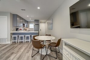 Enjoy a modern kitchen and dining area with a round table and microwave.