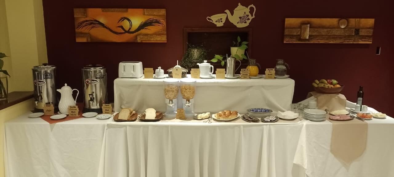 A breakfast buffet with various food items and coffee machines.