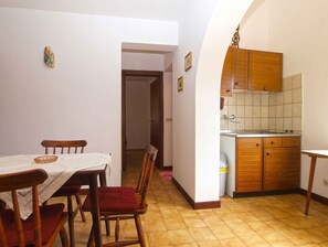Enjoy meals in the dining area with a wooden table and chairs.