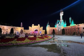 A castle-like structure with a moat and a fountain in the foreground. - Fuxing Hotel (Beijing)