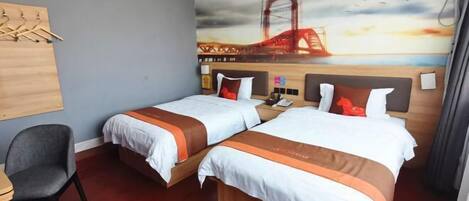 A hotel room with two beds, a desk, and a chair. There is a mural of a bridge on the wall.