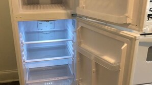 A white refrigerator with multiple shelves and a freezer compartment.