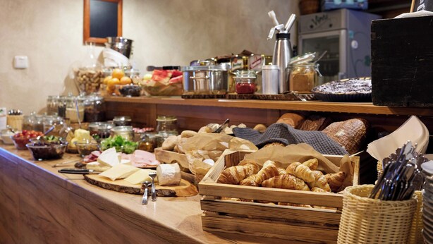 A buffet with various food items including pastries, cheeses, and fruits. - Resort Pasečná (Prední Výton)