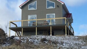 A two-story house with a balcony, a red roof, and a large window on the second floor. - Million Dollar View Home by New River Gorge Park (Cool Ridge)