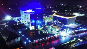 A hotel with a modern design, featuring a prominent dome and a rectangular building with a flat roof. - VINMILAN Hotel & Resort (Asaba)