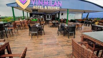 Vinmilan Hotel & Resort with outdoor seating and a covered patio area.
