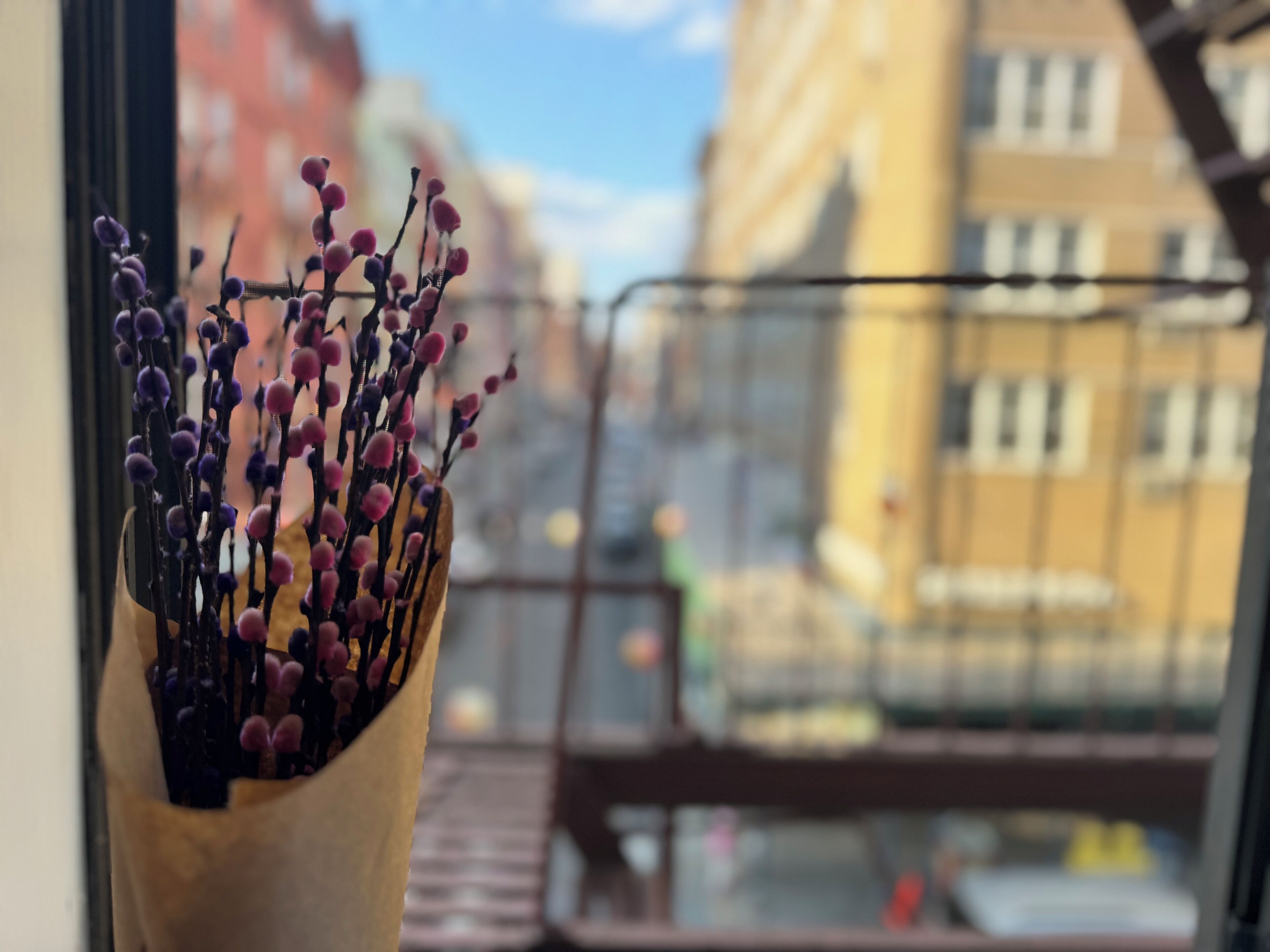 A window with a view of a building and a balcony.