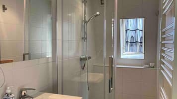 Shower, hair dryer, towels, shampoo