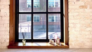 A large window with a giraffe-patterned valance, a vase with a candle, and a teapot on the windowsill. - NEW luxury retro loft in heart of historic, walkable Southside district  (Chattanooga)