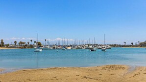 A marina with multiple boats docked along the shore.