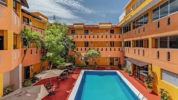 Relax in the hotel's central courtyard, surrounded by lush greenery and comfortable seating areas.