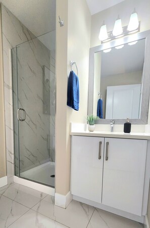 Shower, hair dryer, towels, soap