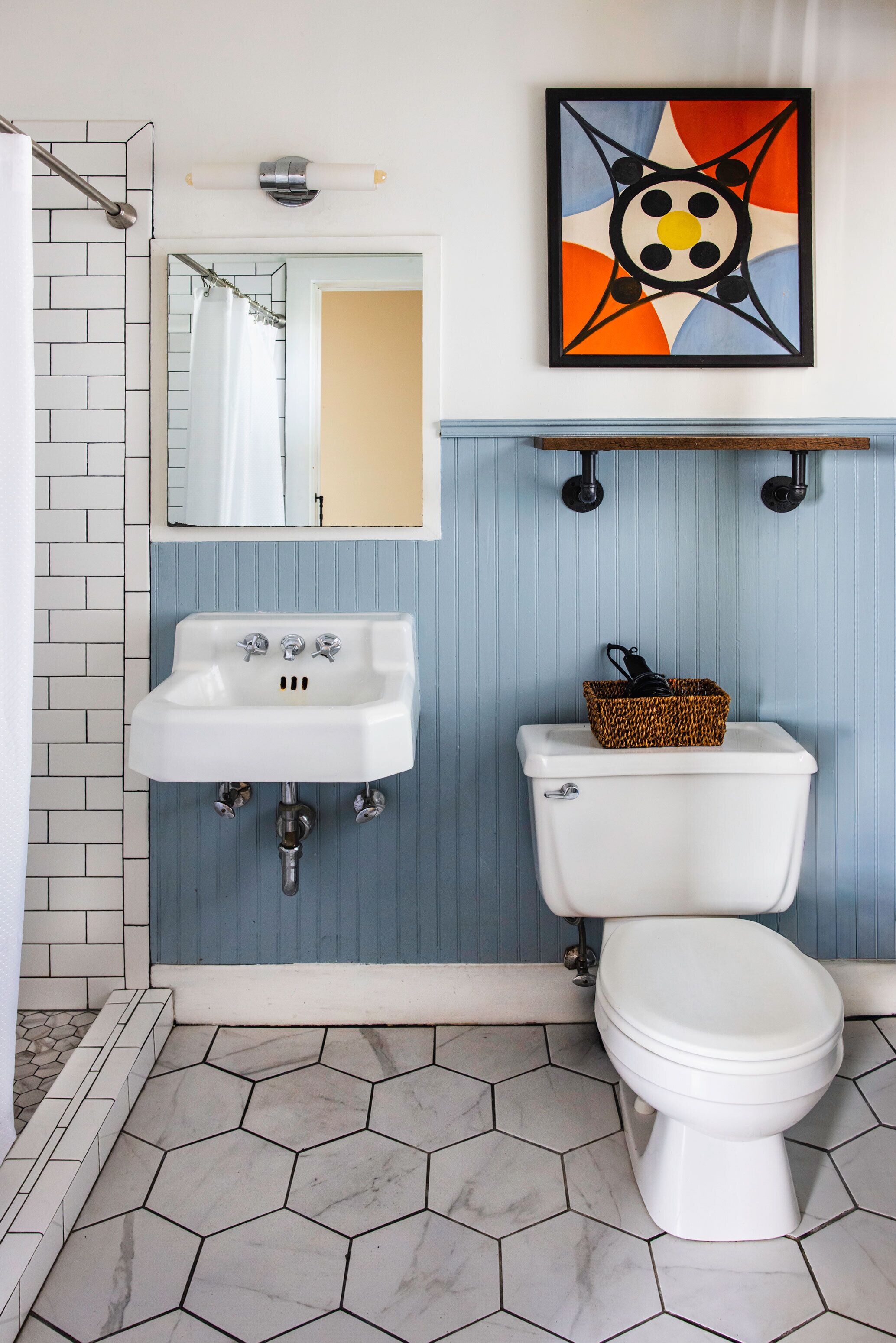 A bathroom with a white sink, a toilet, and a shower.