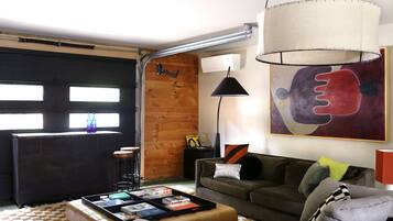 A modern living room with a sofa, coffee table, and artwork.