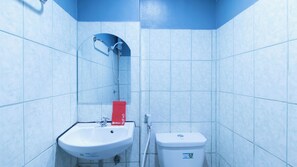 A bathroom with a white sink, a red towel, and a white toilet. - Reddoorz @ Good 101 Quiricada Manila (Manila)