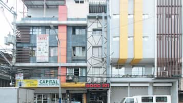 A multi-story building with various commercial establishments, including a medical supplies store and a food service.