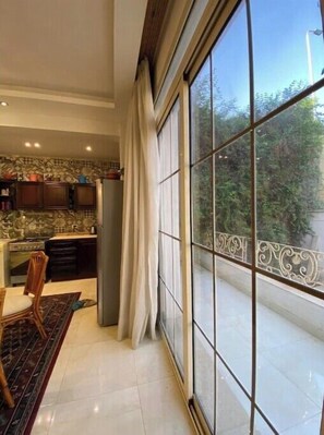 Enjoy meals in this kitchen with a view, featuring a dining table and chairs.
