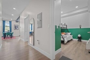 2 habitaciones, escritorio y tabla de planchar con plancha