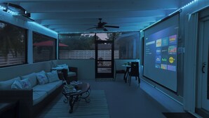 A cozy living room with a sofa, coffee table, and a TV screen displaying streaming services. - Casa Bay-Spacious Family Friendly 4 Bedroom Home with Ultimate Backyard Fun! (Cutler Bay)