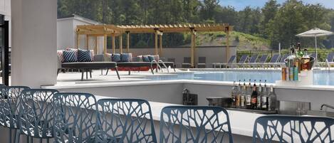 A poolside bar area with seating and a bar counter.