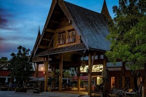 A traditional wooden building with a sloped roof and a covered porch area. - Naina Resort & Spa Phuket (Phuket)