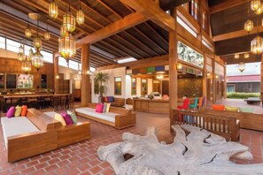 A spacious lobby with wooden beams, seating areas, and hanging lights. - Naina Resort & Spa Phuket (Phuket)