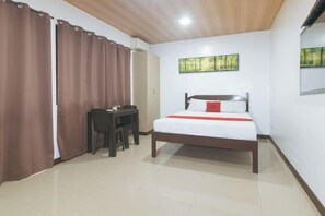 A bedroom with a bed, a desk, and a chair. - RedDoorz @ RJs Bldg near Lyceum Gen Trias Cavite (General Trias)