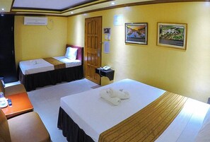 A hotel room with two beds, a desk, and a telephone. - Reddoorz Plus @ Taj Hotel Tuguegarao (Tuguegarao)