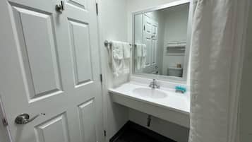 Bathtub, towels, soap, shampoo