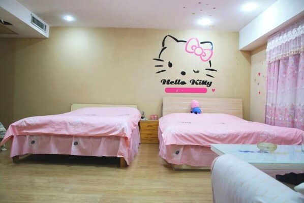 A room with two beds, each covered with pink bedding. A Hello Kitty decal is on the wall above the beds. - Mizilan Zhengzhou Hotel (Guomao 360) (Zhengzhou)