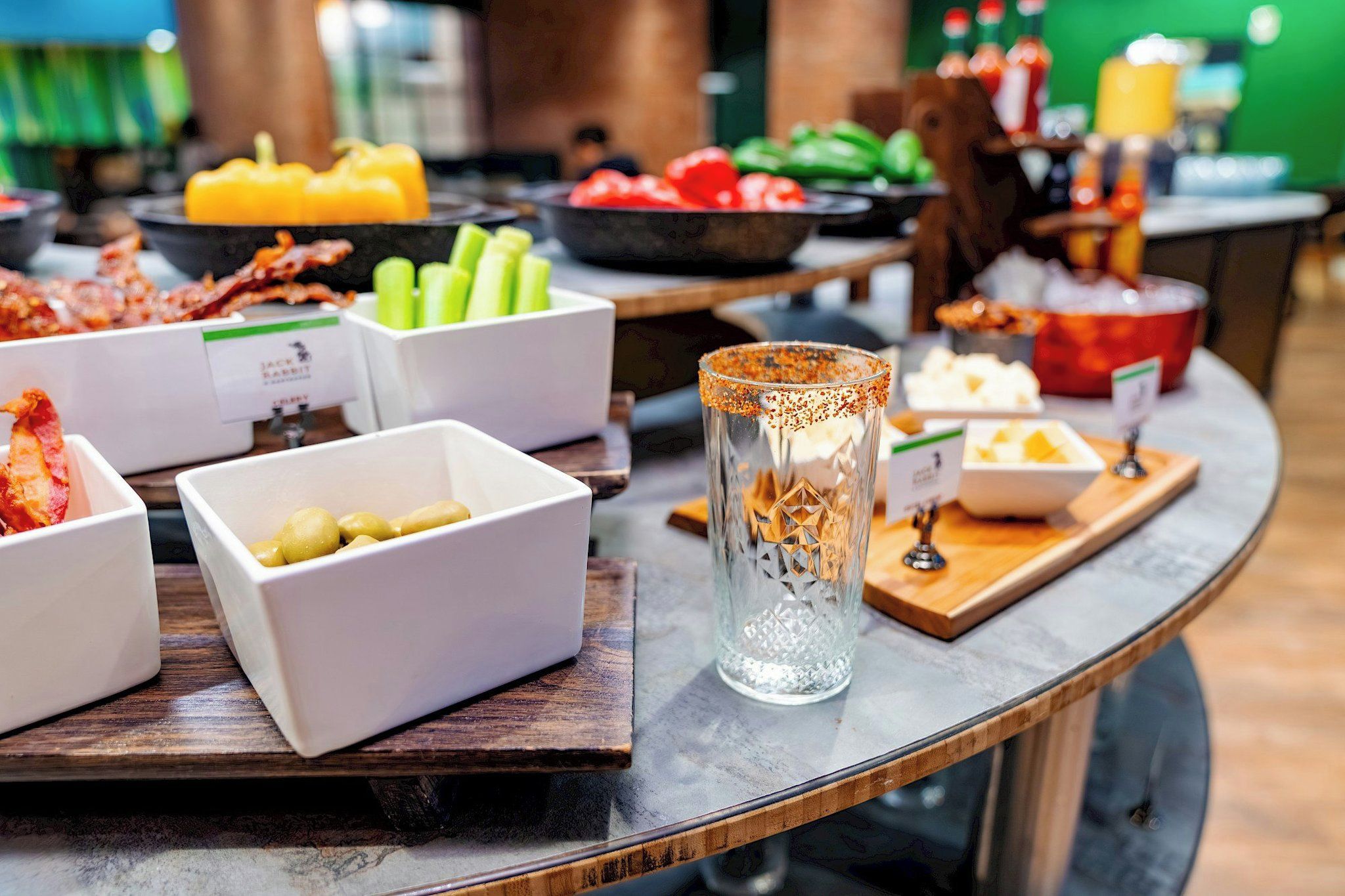 Une table de buffet garnie de divers plats et agrémentée d’un centre de table décoratif en verre.