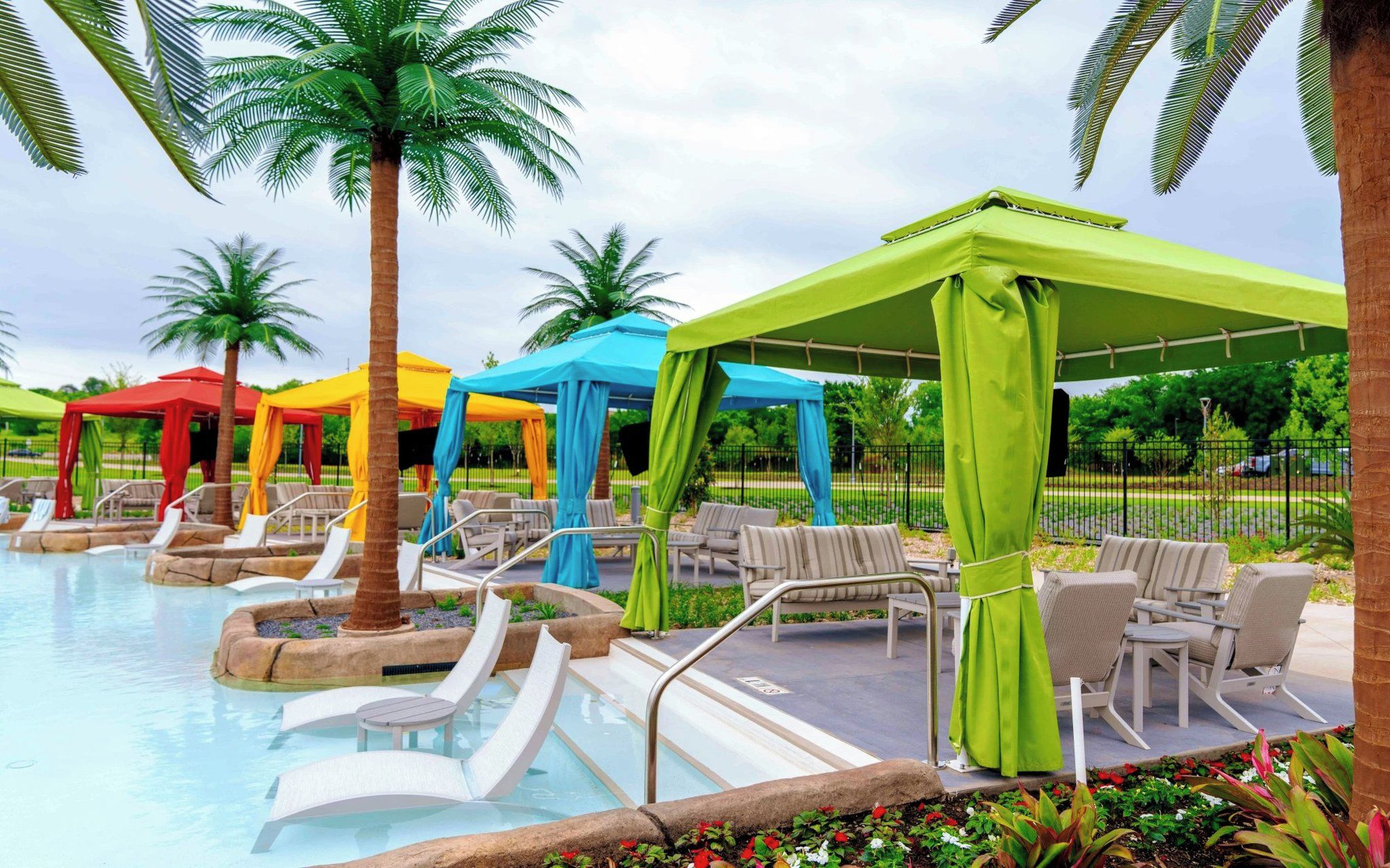 A pool area with lounge chairs and umbrellas.
