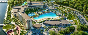 A resort with a large swimming pool, a water park, and multiple buildings. - OKANA Resort & Indoor Waterpark (Oklahoma City)