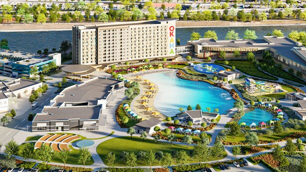 A hotel with a large building, a swimming pool, and a landscaped area with pathways and greenery. - OKANA Resort & Indoor Waterpark (Oklahoma City)
