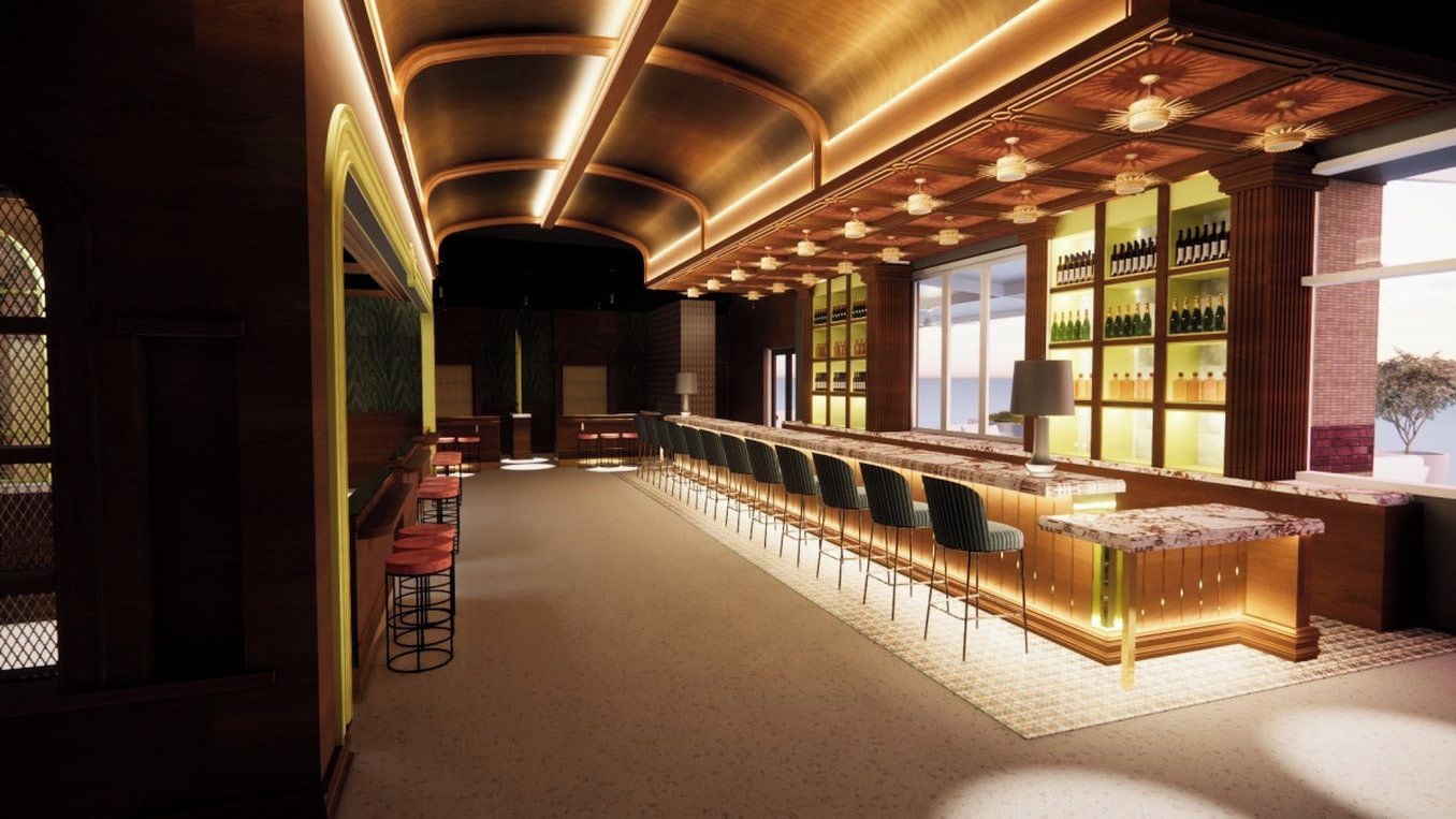 A bar area with a long counter, bar stools, and shelves with bottles.