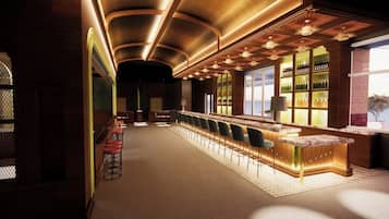 A bar area with a long counter, bar stools, and shelves with bottles.