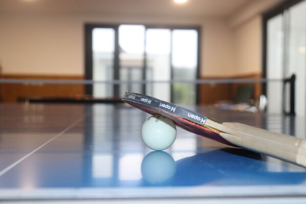 A pool table with a cue stick and a white cue ball.
