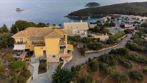 A coastal residential area with houses, a road, and a view of the sea. - The Dandy Horizon (Igoumenitsa)