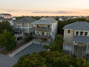 A multi-story residential building with a balcony, a covered porch, and a garage. - Private Beach Access |Sound Views |Elevator (Surf City)