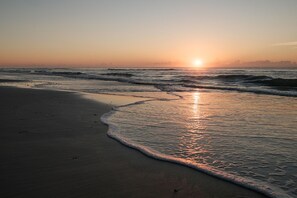 A beach with waves at sunset. - Private Beach Access |Sound Views |Elevator (Surf City)