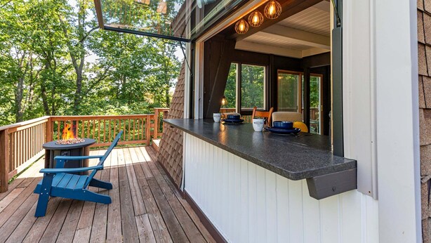 A deck with a fire pit, outdoor seating, and a view of the surrounding trees. - Country Squire Cabin - private 180 degree mountain views! (Basye)