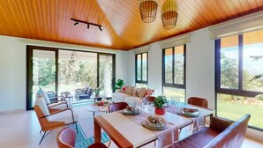 A spacious dining area with a wooden ceiling, large windows, and modern furniture. - Casa de Verano in Valle Bonito

 (Provincia de Panamá Oeste)