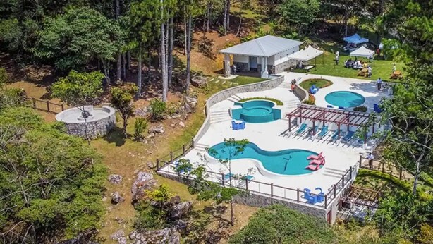 An aerial view of a resort with multiple swimming pools, a gazebo, and a natural forested backdrop. - Casa de Verano in Valle Bonito

 (Provincia de Panamá Oeste)